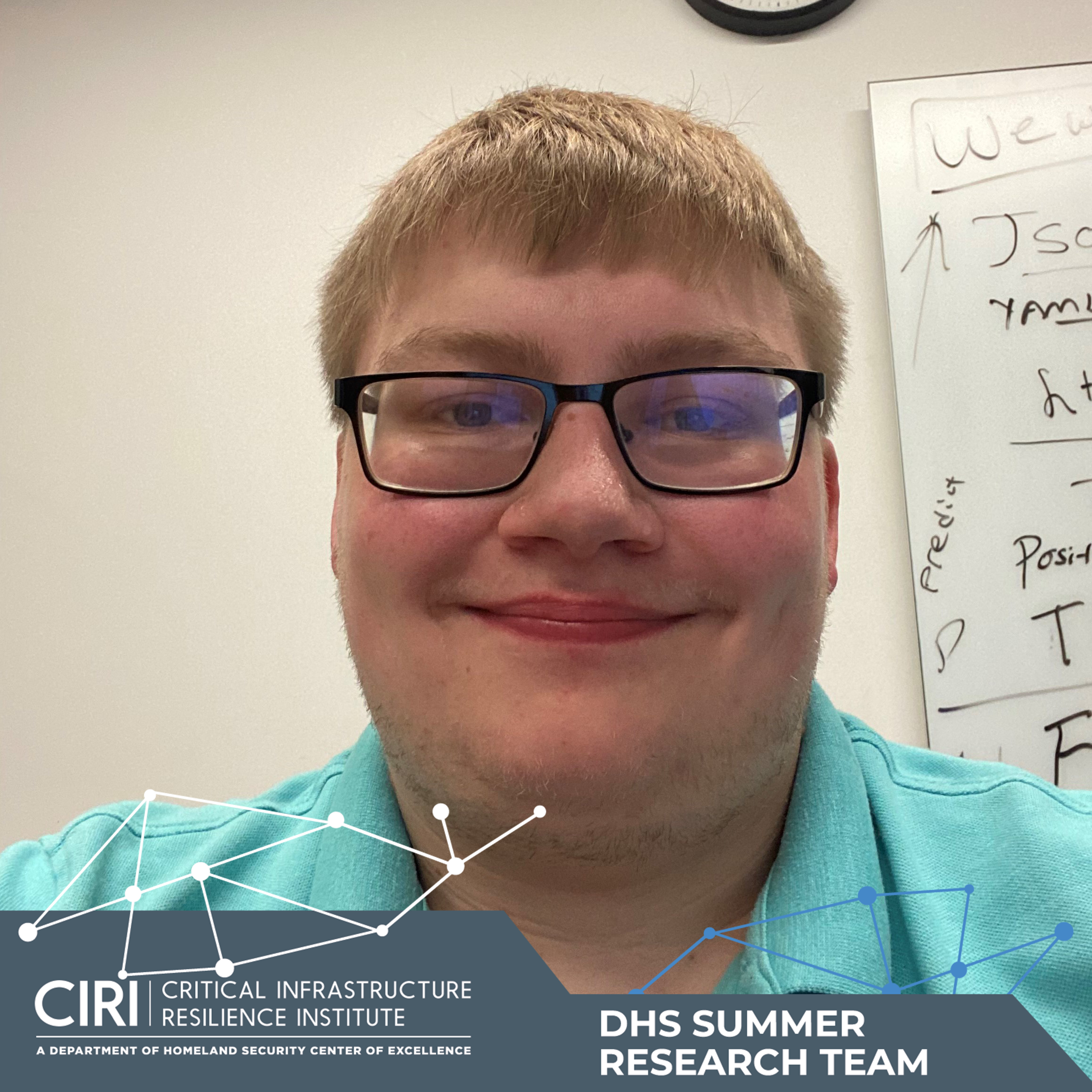 Photo of Jarod Costello with DHS Summer Research Team banner