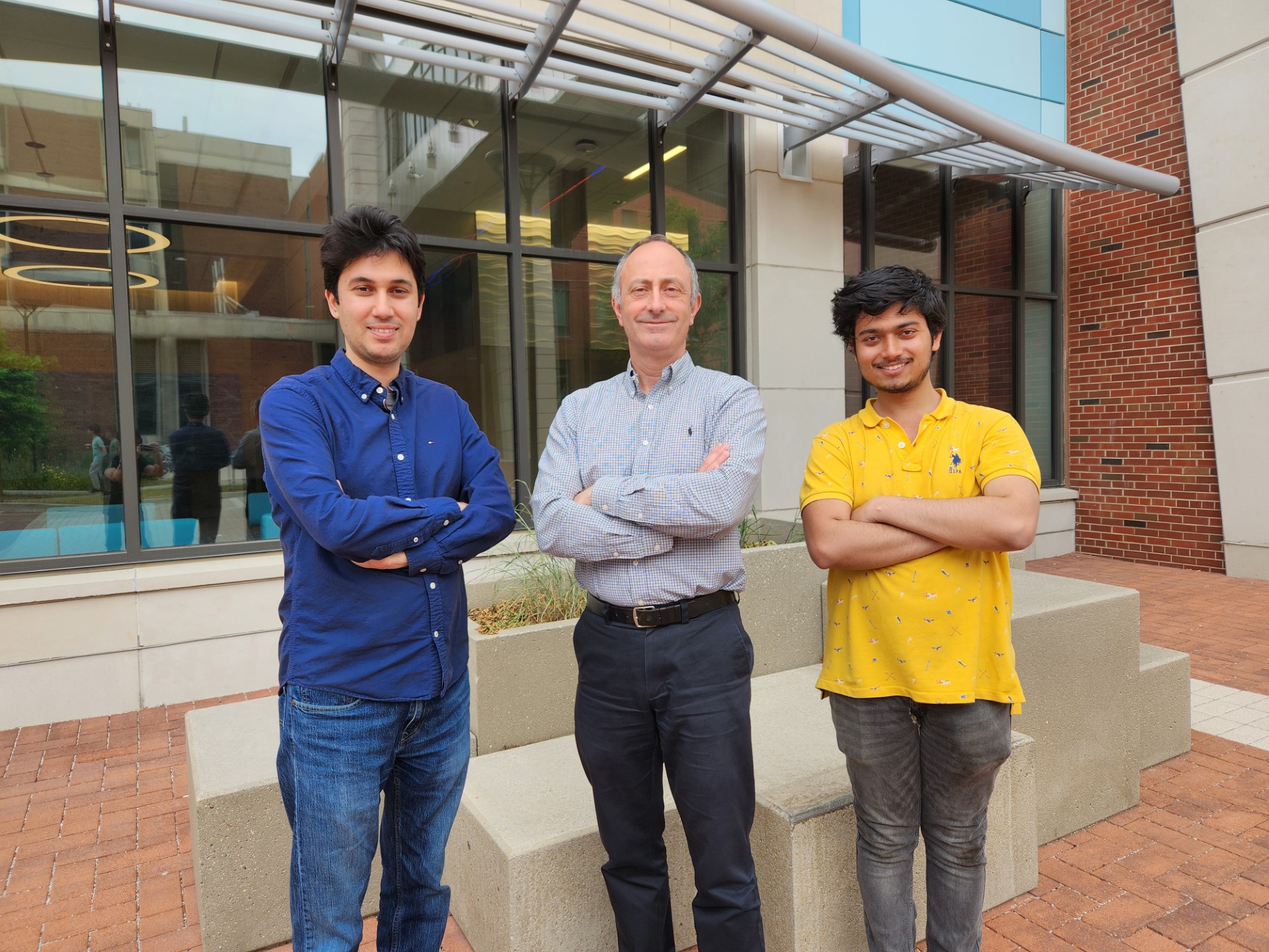 Wildfire researchers. Three men standing in front of a building.