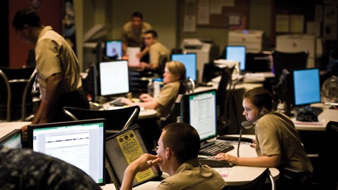 employees working at their computers in a large office